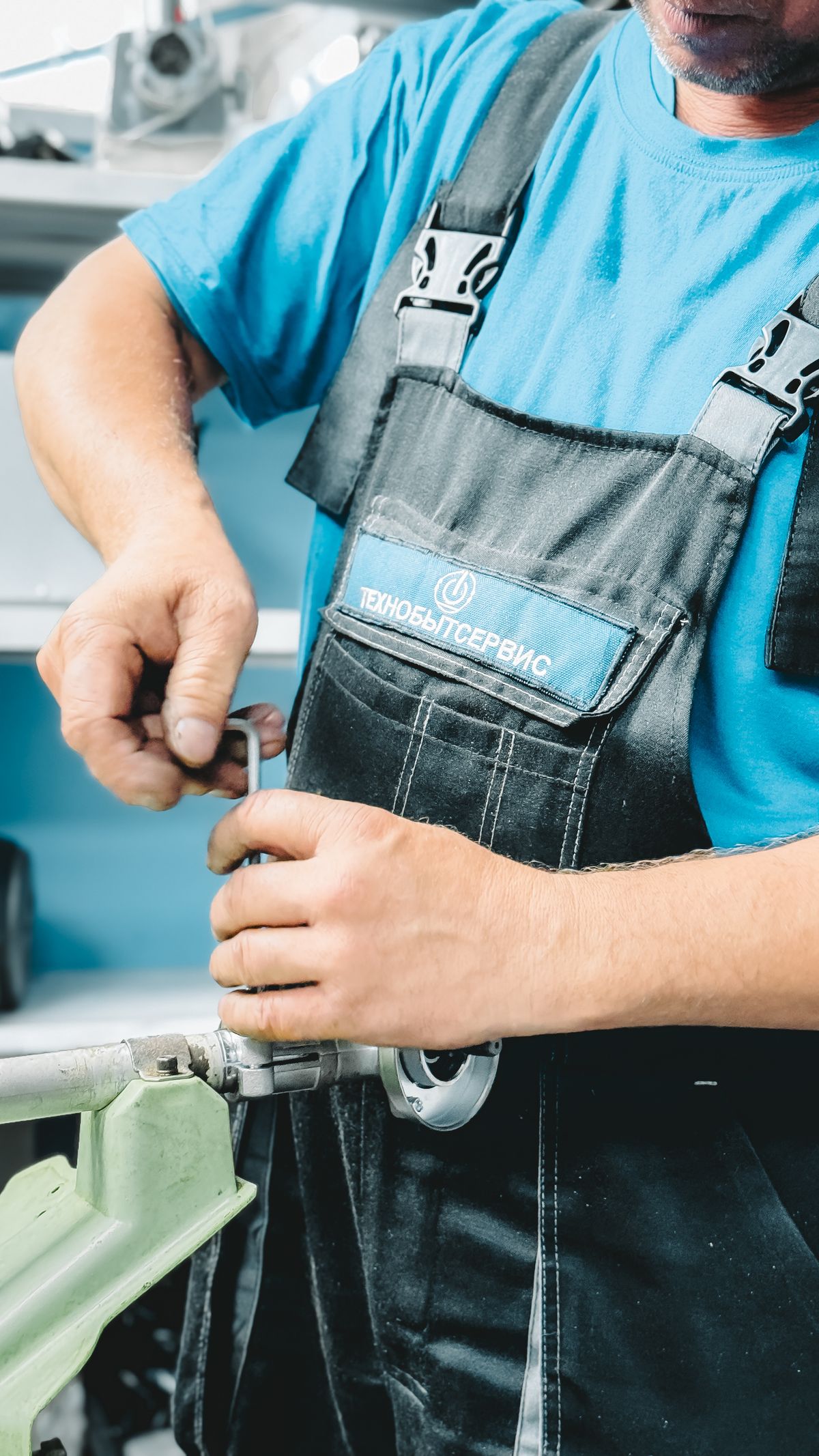 A plumber repairing a pipe under a sink